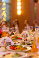 Served festive table with snacks, glasses, glasses, cutlery and napkins for a banquet