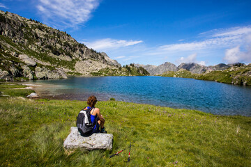 Young hiker girl summit to Montardo Peak in AIguestortes and Sant Maurici National Park, Spain