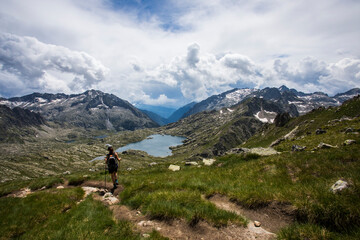 Fototapeta na wymiar Young hiker girl summit to Montardo Peak in AIguestortes and Sant Maurici National Park, Spain