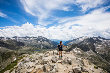 Fototapeta premium Young hiker girl summit to Montardo Peak in AIguestortes and Sant Maurici National Park, Spain