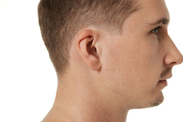 Close up of male ear on white studio background