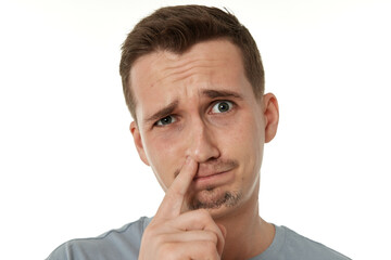 man is picking his nose isolated on white background.