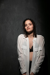 Portrait of a beautiful woman in a white shirt and black bra