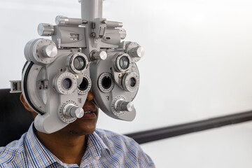  african american at the optometrist having an eye test for new spectacles