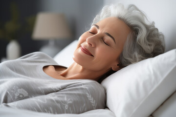 Obraz na płótnie Canvas Senior brunette woman sleeping well on white pillow in bed