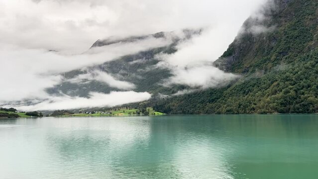 A scene of a very rainy day at Oldevatnet Lake and the Briksdal Valley, Norway