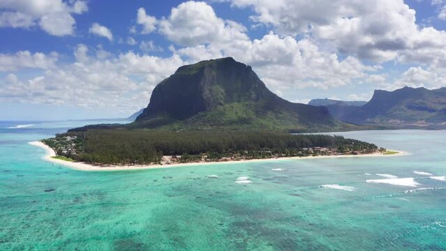Turquoise clean lagoons protected by coral reefs of Le Morne peninsula with basalt mount on Mauritius island. Also a wonderful kiteboarding and windsurfing spot. Exotic traveling aerial 4K video.
