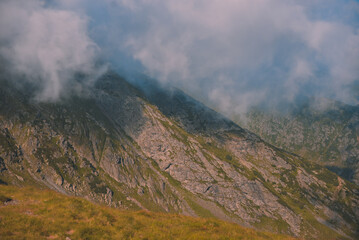 Amazing landscape in Fagaras mountains with spectacular white clouds and blue sky in Romania