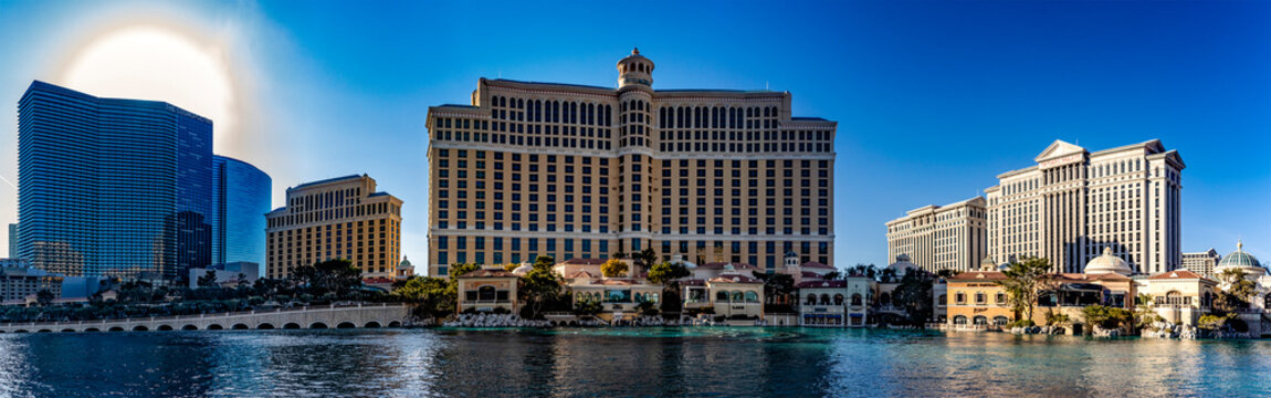 Las Vegas, USA; January 18, 2023: Photo lake of the Bellagio hotel and casino, with Caesars Palace in the background on the Las Vegas Strip, the city of gambling, vice and sin under a blue sky.