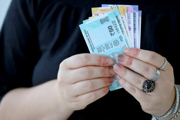 Woman hand with indian rupees bills close up. Concept of financial operations in cash in India