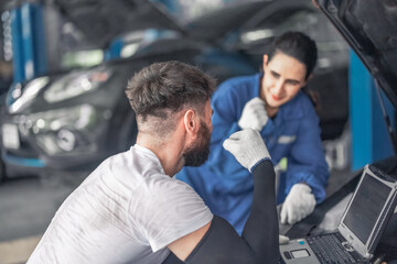 Car technician use computerized diagnostic to analyze, fix, repair engine, ensuring top performance