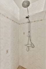 a shower in a tiled bathroom with a shower