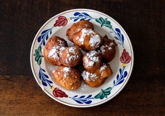 Traditional dutch oliebollen with powdered sugar on the plate 