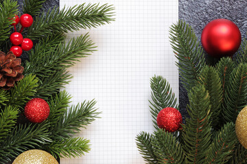 Happy New Year 2024, gray background with fir branch and notepad. New Year card, banner, top view, empty space. Copy space. Christmas branch and notepad