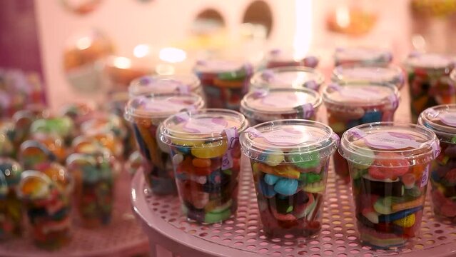 Marmalade gummy candies multicolored stand on the counter of a candy store. concept sweets for children chewing gum