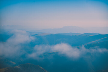 Sharp mountain peaks seen in stunning light from high altitude. Fairy tale landscape with wild...