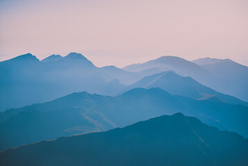 Sharp mountain peaks seen in stunning light from high altitude. Fairy tale landscape with wild...