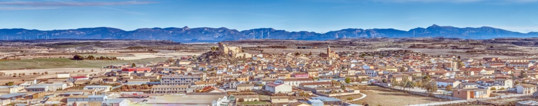 Drone panorama of the village of Almudevar in northern Spain with the Pyrenees in the background