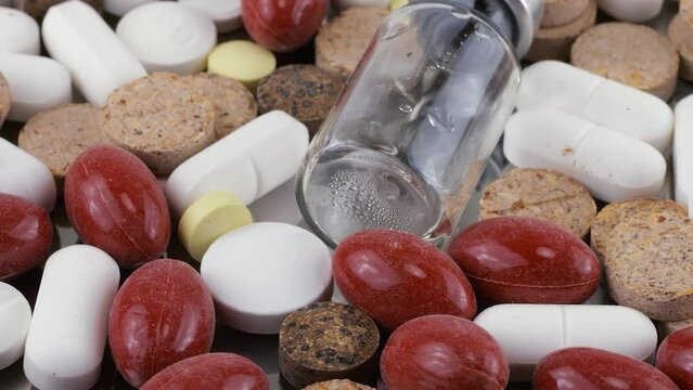 Pharmacy background on a metal surface. Tablets, pills, glass flacons and ampoule. Medicine and healthy. Close up of capsules.