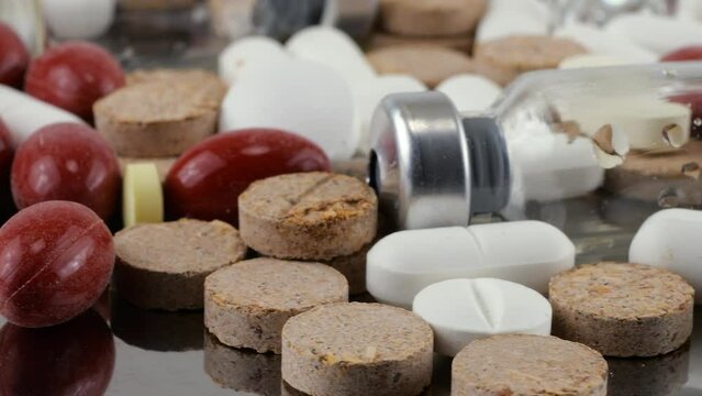 Pharmacy background on a metal surface. Tablets, pills, glass flacons and ampoule. Medicine and healthy. Close up of capsules.