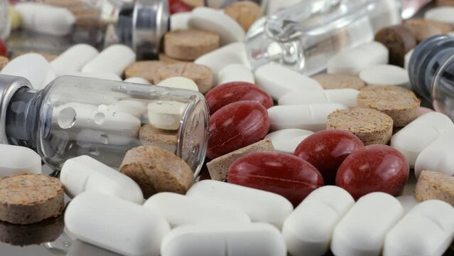 Pharmacy background on a metal surface. Tablets, pills, glass flacons and ampoule. Medicine and healthy. Close up of capsules.