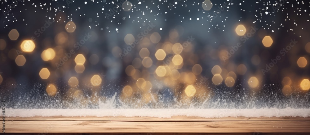 Poster christmas themed wood table with snowy background and bokeh lights suitable for product display or m