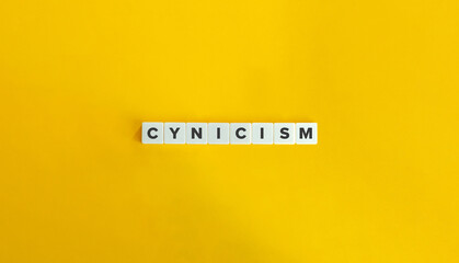 Cynicism Word on Block Letter Tiles on Yellow Background. Minimal Aesthetic.