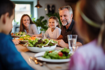 A happy family having a good time and enjoying lunch together at home, sharing moments of laughter and jokes.