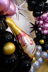 Birthday party with balloons for an adult. Black balloons and wine bottle shaped balloon