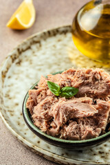 Canned tuna fillet meat in olive oil. vertical image. top view. copy space for text