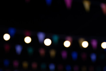 blur of colorful lights in an outdoor amusement park at night. The temple fair is an annual...