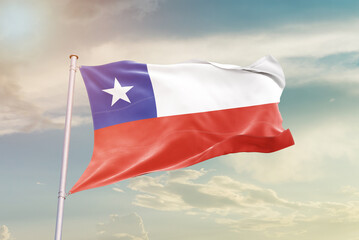 Chile national flag waving in beautiful sky. The symbol of the state on wavy silk fabric.