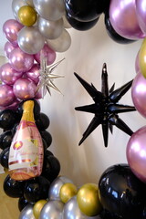 Birthday party with balloons for an adult. Black balloons and wine bottle shaped balloon
