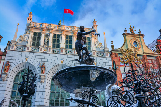 Sunrise in the historic center of Gdansk with the Neptune fountain at winter, Poland.