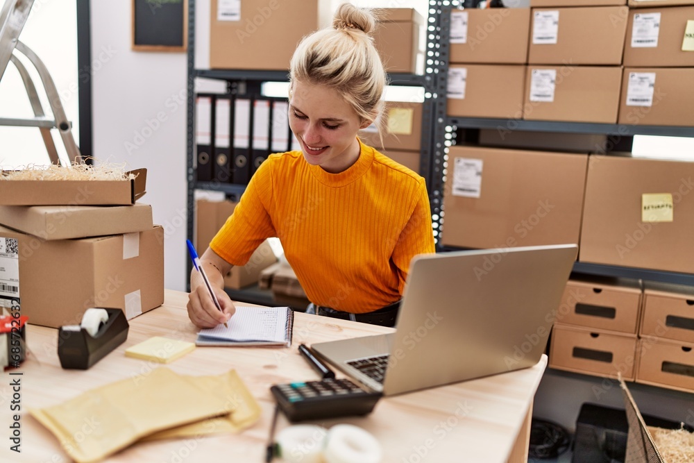 Canvas Prints young blonde woman ecommerce business worker using laptop taking notes at office