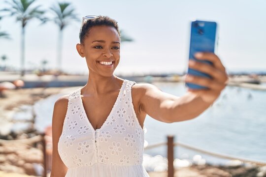 African american woman smiling confident making selfie by the smartphone at seaside