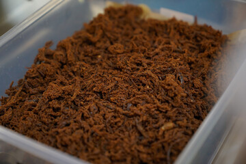 Minced empal meat in a white box close up, daging empal suwir