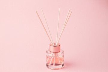 Bottle of room fragrance on a pink background