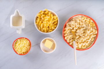 Creamy mac and cheese with ingredients for cooking
