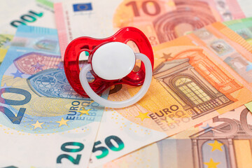 Childfree, Contraception and Birth Control Concept: Baby Pacifier on the Euro Banknotes. Having Children is Expensive and Unprofitable - obrazy, fototapety, plakaty