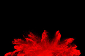 red powder explosion on black background. Colored burst cloud. Color dust explode. Paint Holi