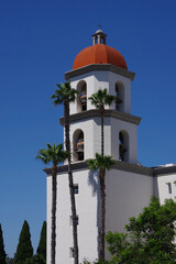 Fototapeta na wymiar Church bell tower under blue sky in southern California