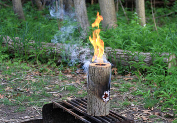 Fire Log special burning on camp grill
