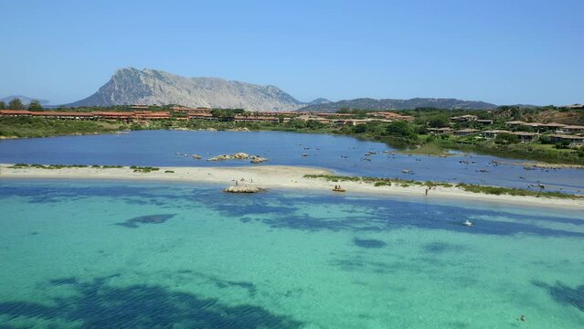 Drone aerial view of Salina Bamba beach with Isola Molara islet on the background in Sardinia, Italy