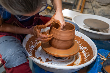 A piece of clay worked on the wheel by a female ceramist