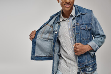 cropped view of stylish african american male model posing in trendy denim outfit, fashion concept