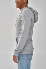 stylish african american man in gray casual sweatshirt and jeans, copy space for advertising