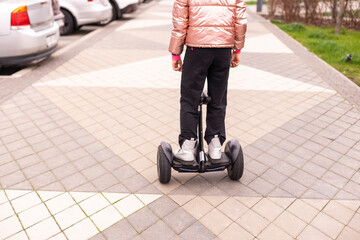 Young girl riding electric mini segway hover board scooter. ecological urban transportation technology. Electric self-balancing scooter board