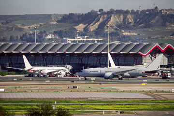 Planes transiting the runways near one of the terminals of Madrid Barajas airport