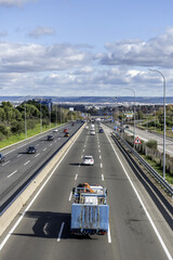Access via the A2 highway to the city of Madrid in an hour of relaxed traffic on a day with cloudy skies